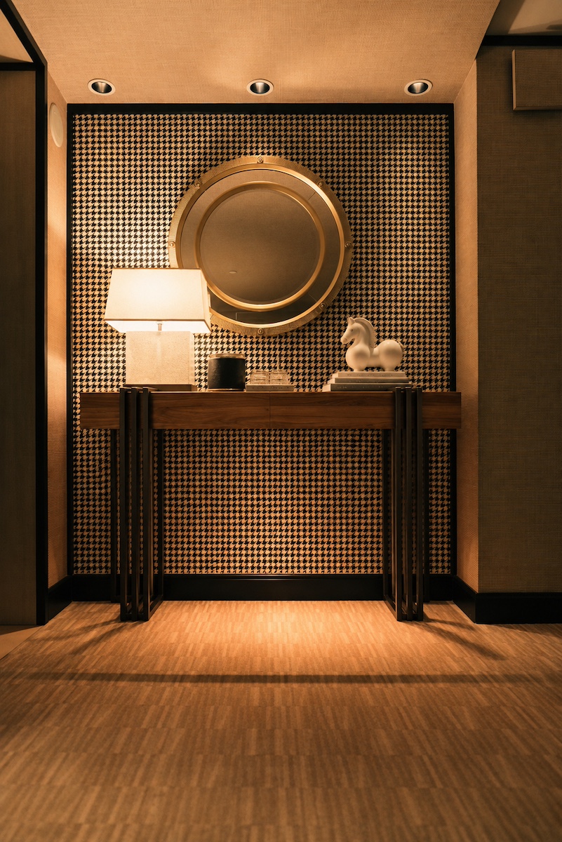 Warm table lighting and a statement mirror in an interior